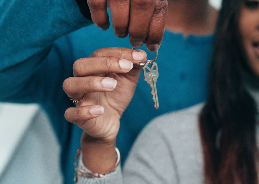 A young couple holding the keys to their new home
