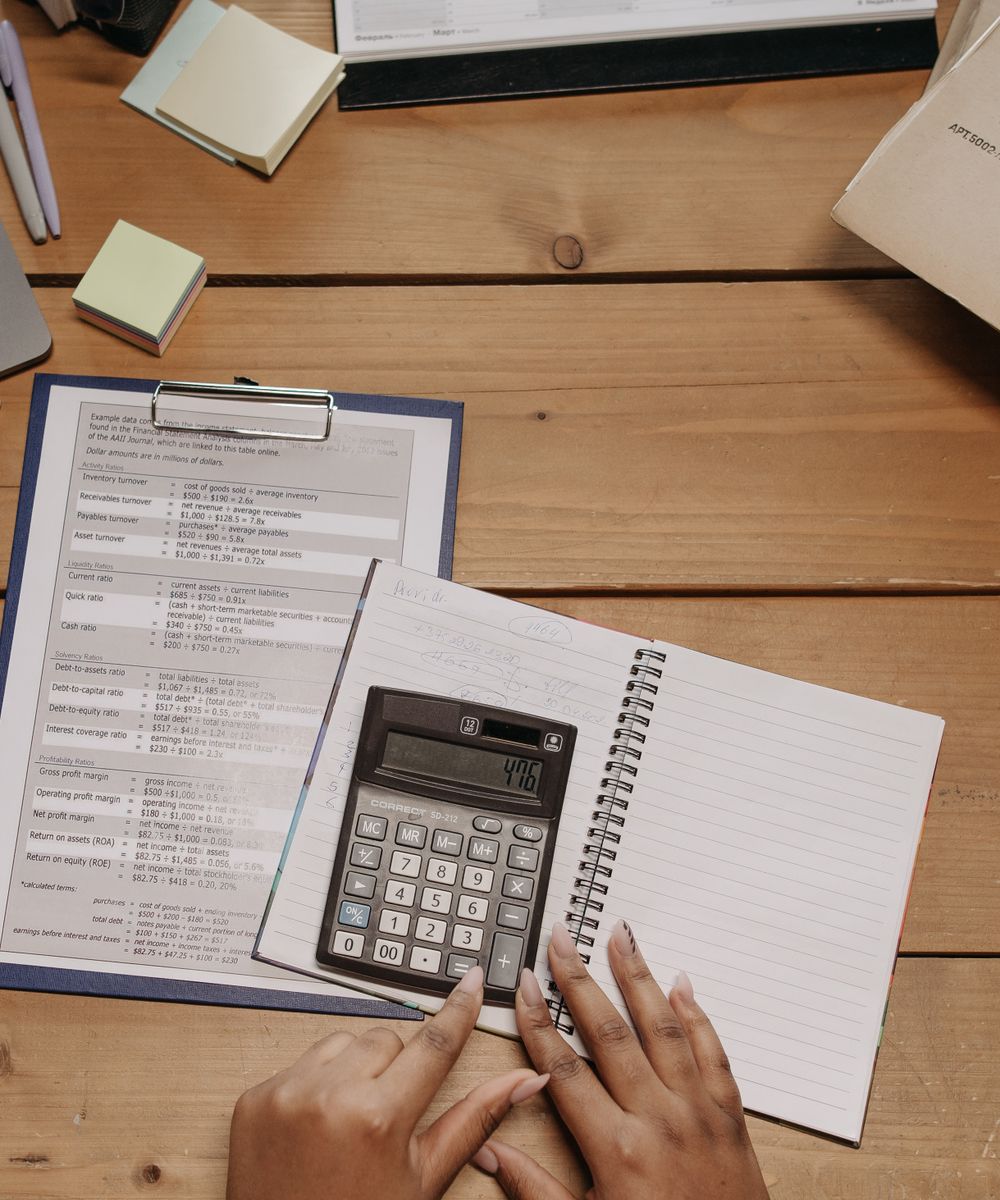 Someone planning bills and savings by hand
