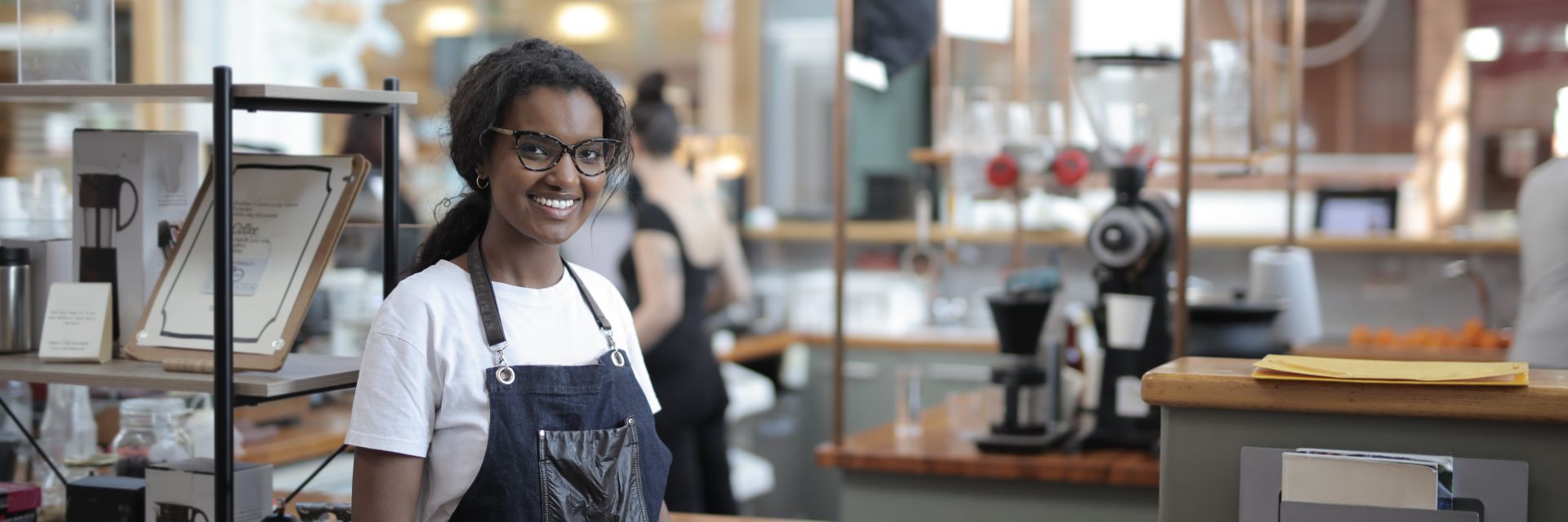 A small business owner smiling in their shop