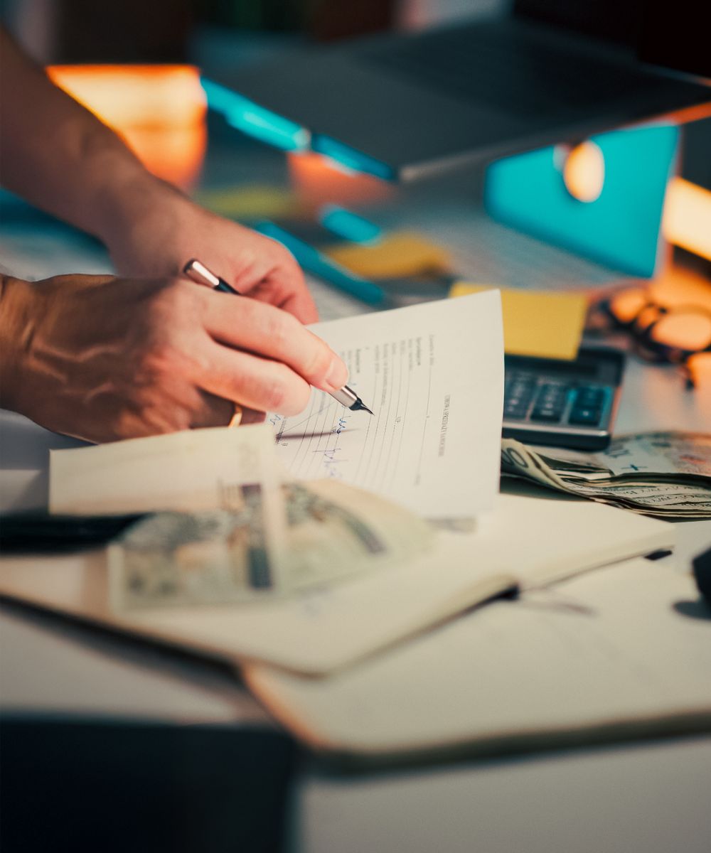 An accountant reviewing business documents with a calculator