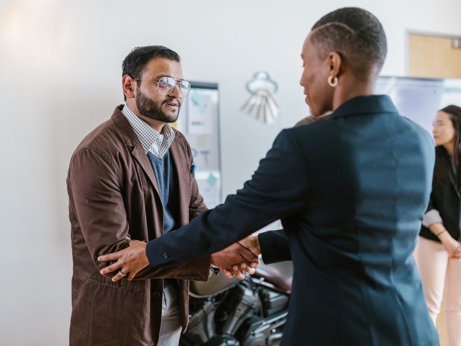 Two people shaking hands at a networking event