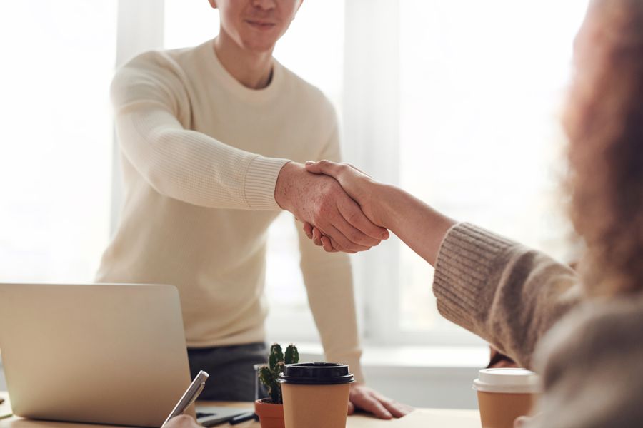 A mentor shaking hands with a program participant