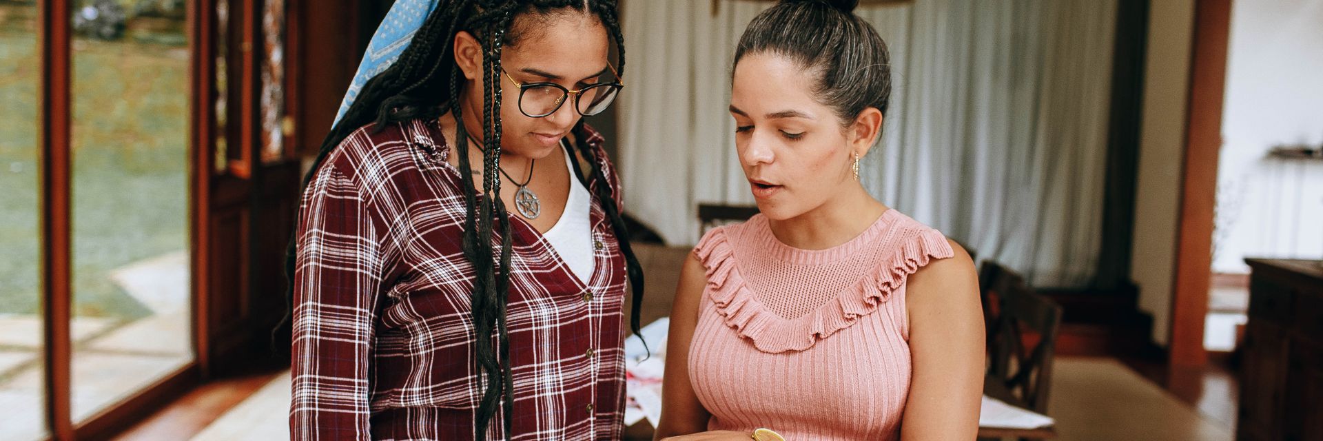 A mentor working through a learning session with a young adult