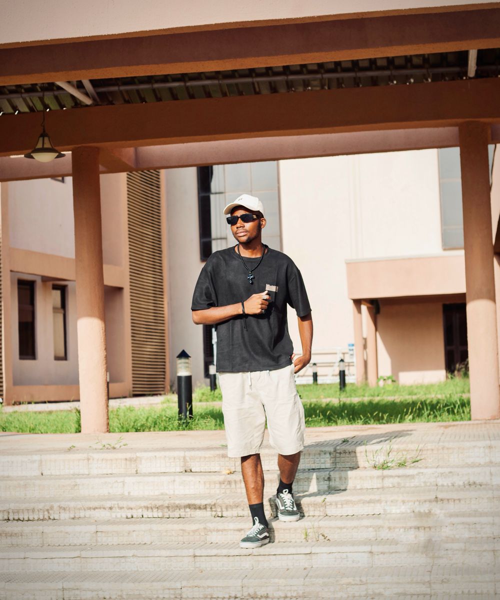 A confident young student smiling on campus